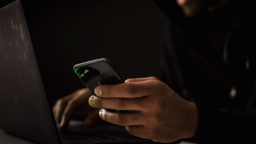 Man on computer and phone